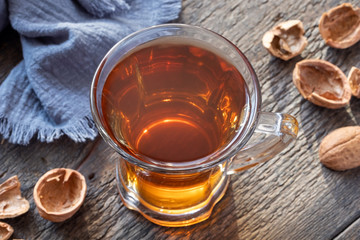 A cup of herbal tea made from walnut shells - folk remedy for cough