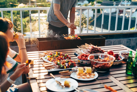 friends barbecuing on rooftop