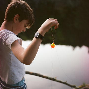 boy holding a bobber while fishing