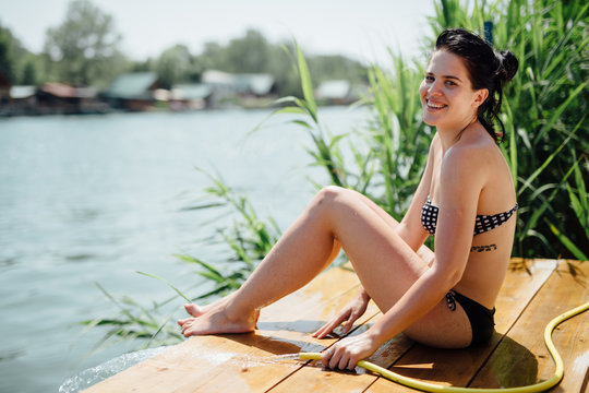 Woman sunbathing on wooden deck