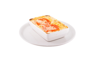 Meat Lasagna. Garnished with red tomatoes. Served on a white plate, shot on a white background. Photo suitable for feeding may restaurant. A dish of Italian cuisine.