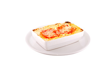 Meat Lasagna. Garnished with red tomatoes. Served on a white plate, shot on a white background. Photo suitable for feeding may restaurant. A dish of Italian cuisine.