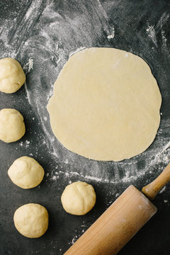 Ball of dough rolled out into thin circle