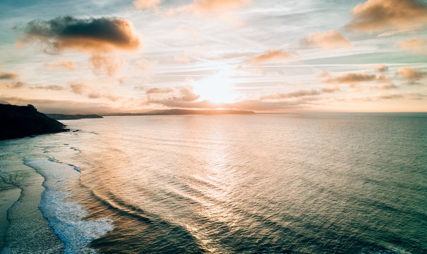 Aerial view of a wild beach at sunset