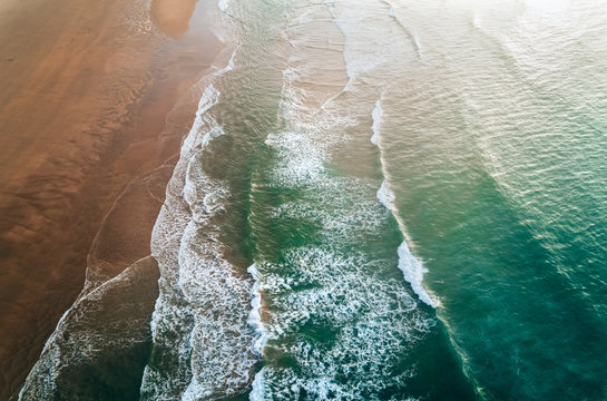 Aerial view of a wild beach at sunset