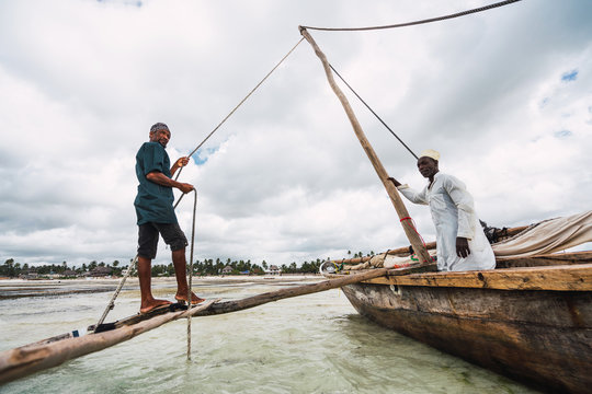 Fishermen on boat in ocean of Zanzibar. The village zanzibari ba