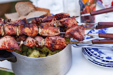 pieces of roasted juicy meat cooked on fire on skewers