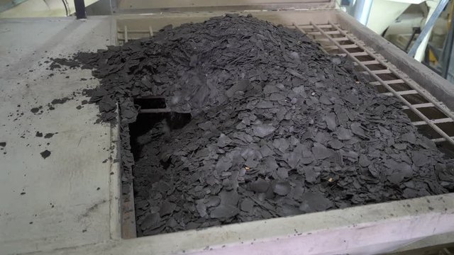Oilcake for adding to animal feed at the feed manufacturing plant. Pile of oilcake