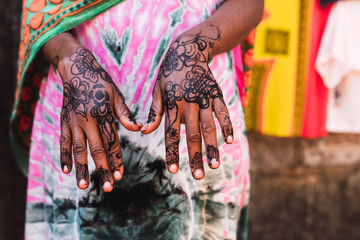 Abstract concept: Close up hands with henna tattoo.