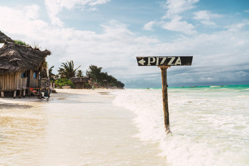 Isolated pizza sign on the zanzibar beach