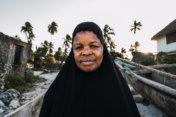 Portrait of a Muslim zanzibari senior woman wearing a black hiyab.
