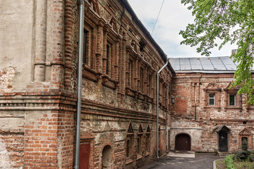 Fototapeta premium The facade of an ancient brick abandoned building