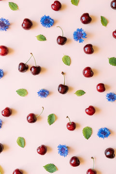 Seamless pattern with cherries, lemon balm leaves and cornflower