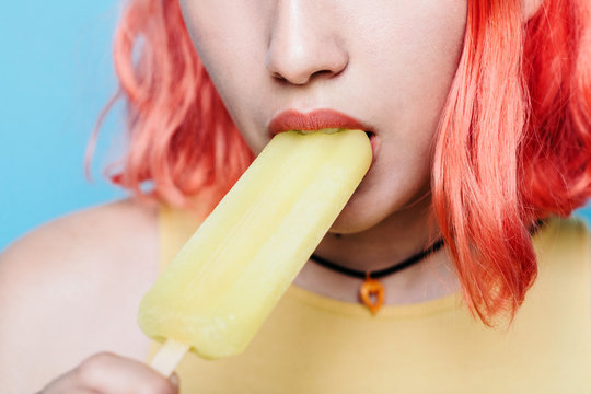 Young woman with lemon ice lolly
