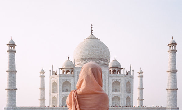 Rear view of woman standing in front of Taj Mahal