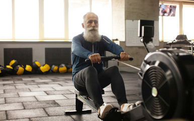 Fototapeta na wymiar Serious bearded senior male is enjoying sporty lifestyle