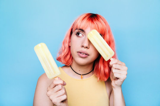 Young woman with lemon ice lollies