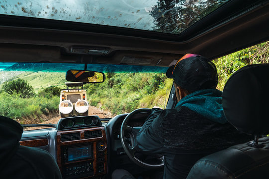 Fototapeta Driving to the safari in Tanzania, on dirt roads. seen from inside the car.