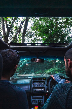 driver and the passenger towards the jungle of Tanzania, views from the inside of a moving car.
