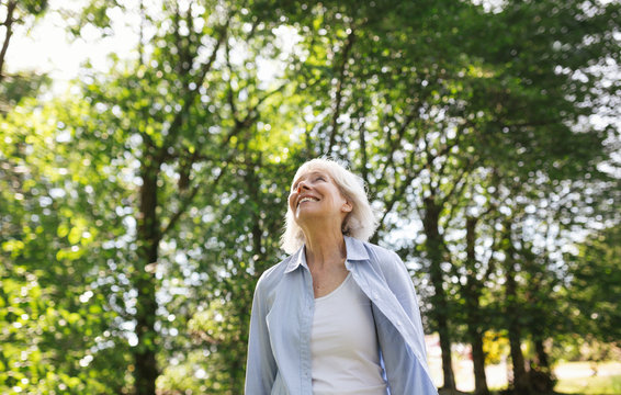 Laughing mature woman outside in nature.
