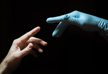 hand in the medical glove touches the other