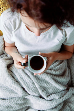 Woman With Warm Tea Under Blanket