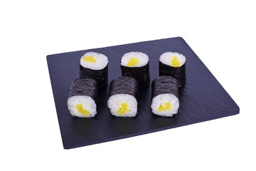 Traditional fresh japanese sushi maki on black stone Maki Daikon on a white background. Roll ingredients: radish daikon, nori, rice.