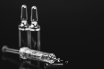 Medical vials for injection with a syringe and ampoules, black and white photo