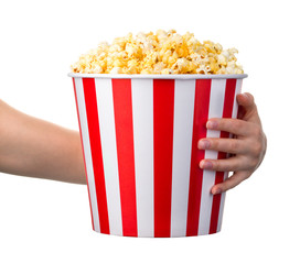 Woman hand holding striped bucket with popcorn isolated on white background