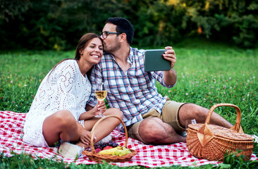 Couple enjoying picnic together. Love and tenderness, dating, romance, lifestyle concept