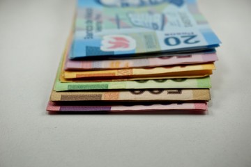 Many mexican pesos bills spread over a surface