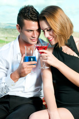 Beautiful couple having a cocktail or a drink in a bar