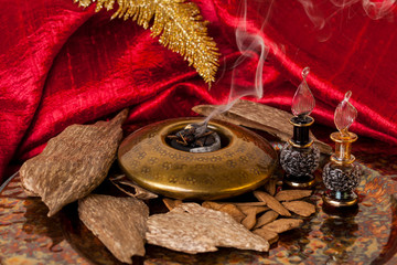Agarwood, also called aloeswood, essential oil and incense chips