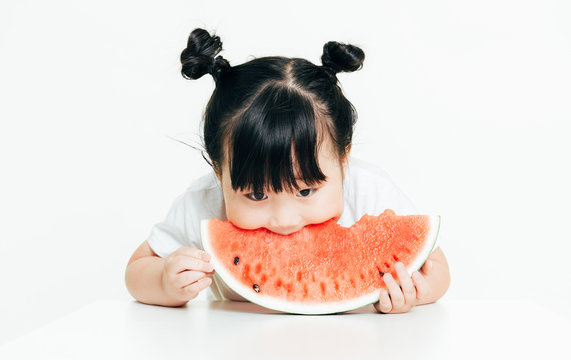 Portrait of cute girl eating watermelon with white background