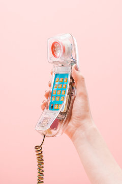 Close Up Of Anonymous Woman Holding Old Plastic Phone On The Pink Background