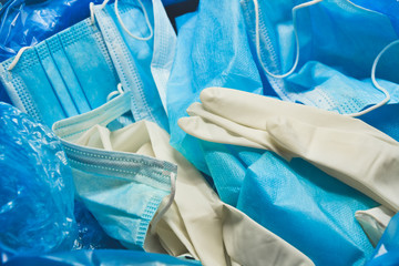 Medical trash. Coronavirus protection equipment in medical waste bin. Used face masks and sterile...