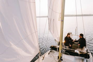 Couple in sailboat on lake