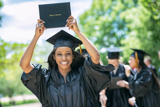 Grad: Pretty Graduate Holds Up Diploma