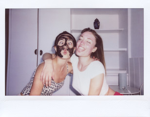 Best friends have fun with face masks.