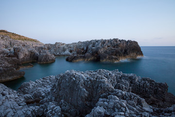 Fototapeta na wymiar beautiful rocky beach at sunset of the Protected Marine Area Costa degli Infreschi and Masseta in the Cilento and Diano Valley National Park, Marina di Camerota, Scario, Salerno, Italy