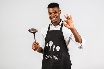 Time to cook! African american man in white shirt and apron, chef cook, comic style with soup ladle gesture of delicious food. Cooking as a battle