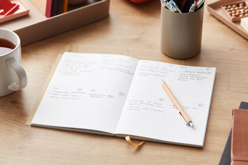 Working table with tea cup and planner
