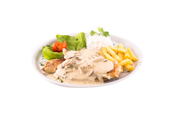 Grilled chicken fillet with cream sauce with mushrooms and french fries. Served on a white plate, melted on a white background. Photo suitable for feeding may restaurant. Dish of Montenegrin cuisine.
