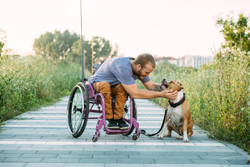 Happy young man in a wheelchair in his daily routine