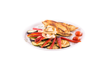 Grilled chicken fillet with fried eggplant, zucchini and red pepper. Served on a white plate, melted on a white background. Photo suitable for feeding may restaurant. Dish of Montenegrin cuisine.
