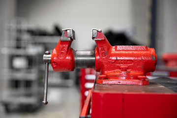 red vise on table in factory