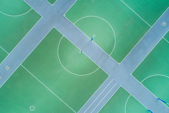 Aerial views over green hard court netball courts and nets