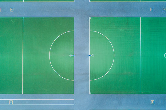 Aerial views over green hard court netball courts and nets
