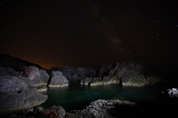 beautiful rocky beach by night of the Protected Marine Area Costa degli Infreschi and Masseta in the Cilento and Diano Valley National Park, Marina di Camerota, Scario, Salerno, Italy