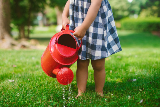 Little girl with watering can